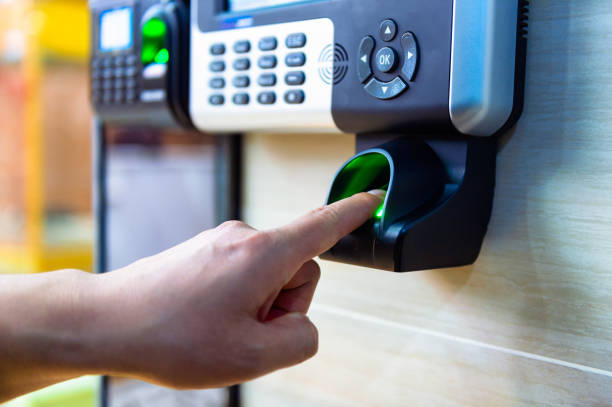 Finger pressing a biometric access control reader