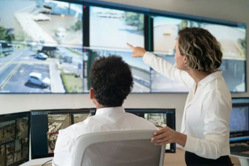 Monitor and phone showing live surveillance feeds